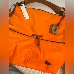 Dooney & Bourke new with tags, small blemish on upper front barely noticeable